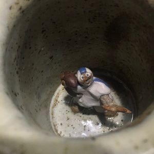 Football player inside coffee mug